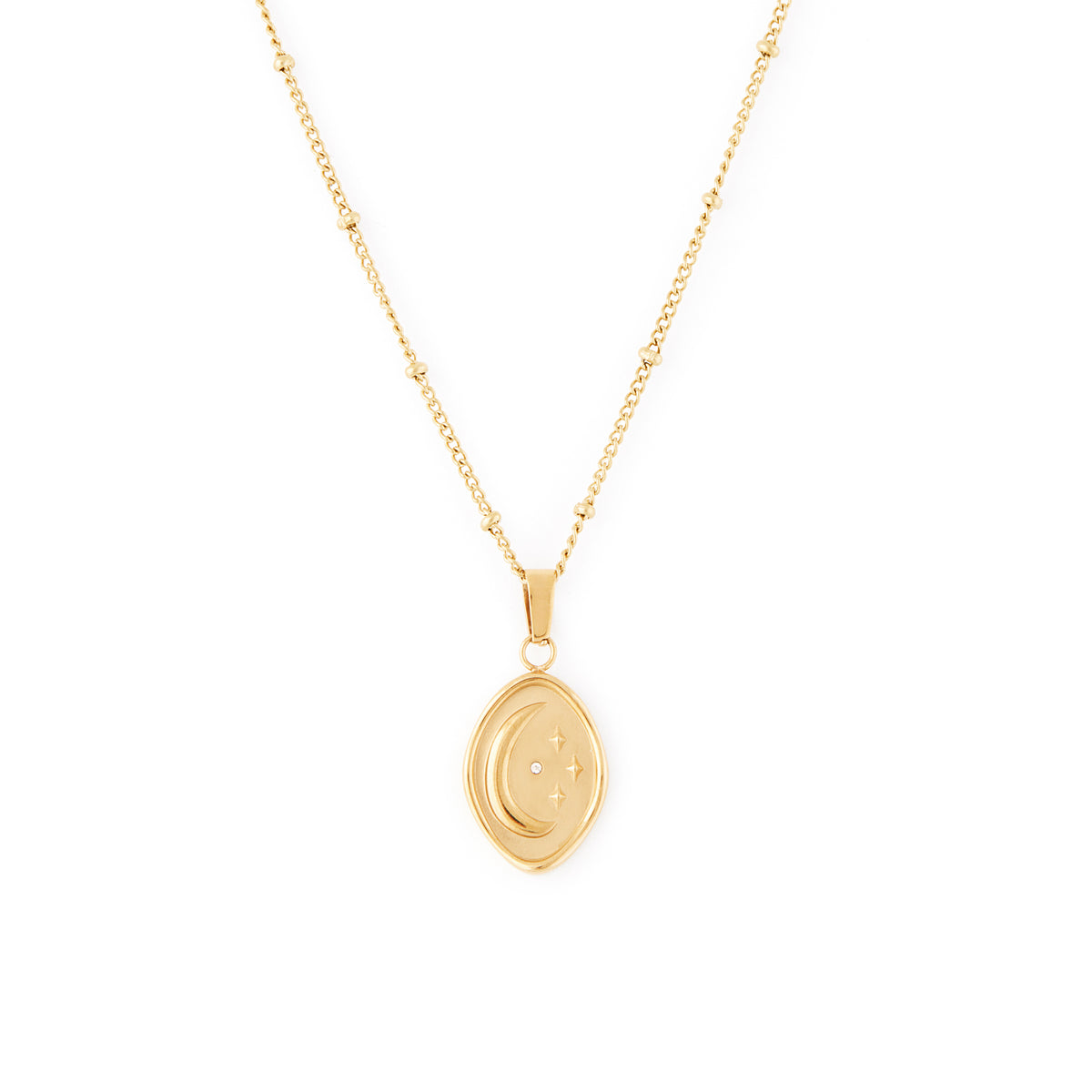 A gold-colored necklace with a beaded chain and an abstract shaped pendant featuring an embossed moon and star with a tiny cubic zirconia stone. Céleste Necklace - Gold