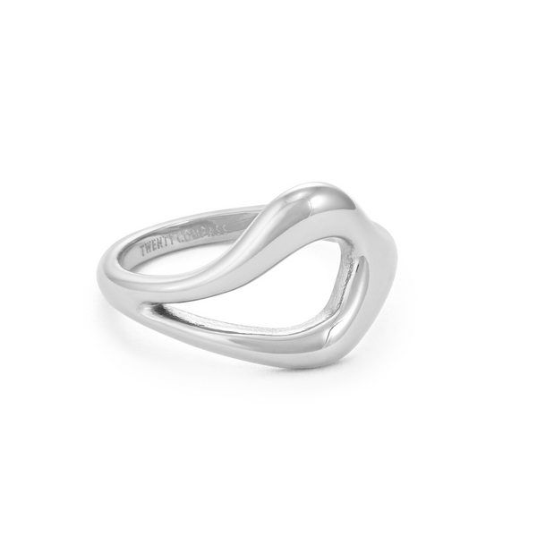 Silver ring with a unique, open, teardrop-shaped design in the center, resting on a white background Gia Ring - Silver