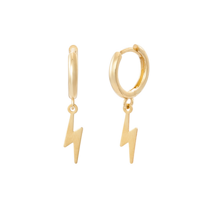 Pair of gold huggie hoop earrings with dangling gold lightning bolt charms.