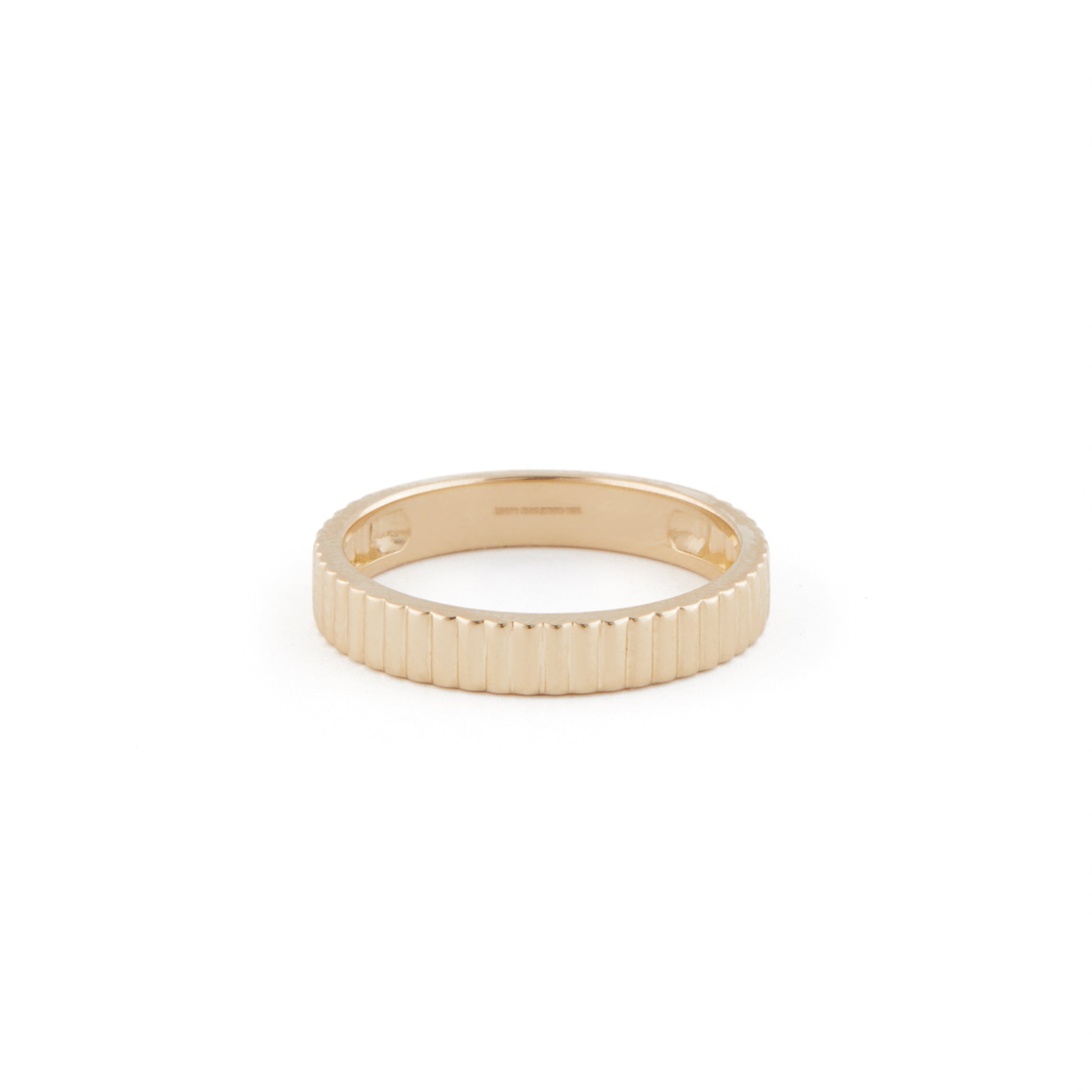 A gold band ring with engraved detailing on a white background.