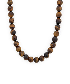 A beaded necklace made of polished round brown tiger's eye beads with natural banding, displayed against a solid white background.