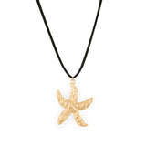 A gold-colored starfish pendant on a black faux suede cord necklace.