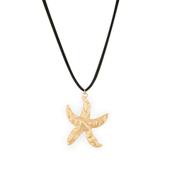 A gold-colored starfish pendant on a black faux suede cord necklace.
