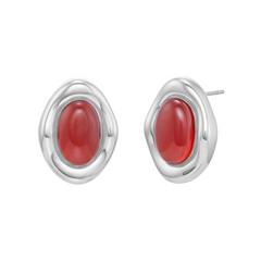 Silver earrings with red stones on a white background