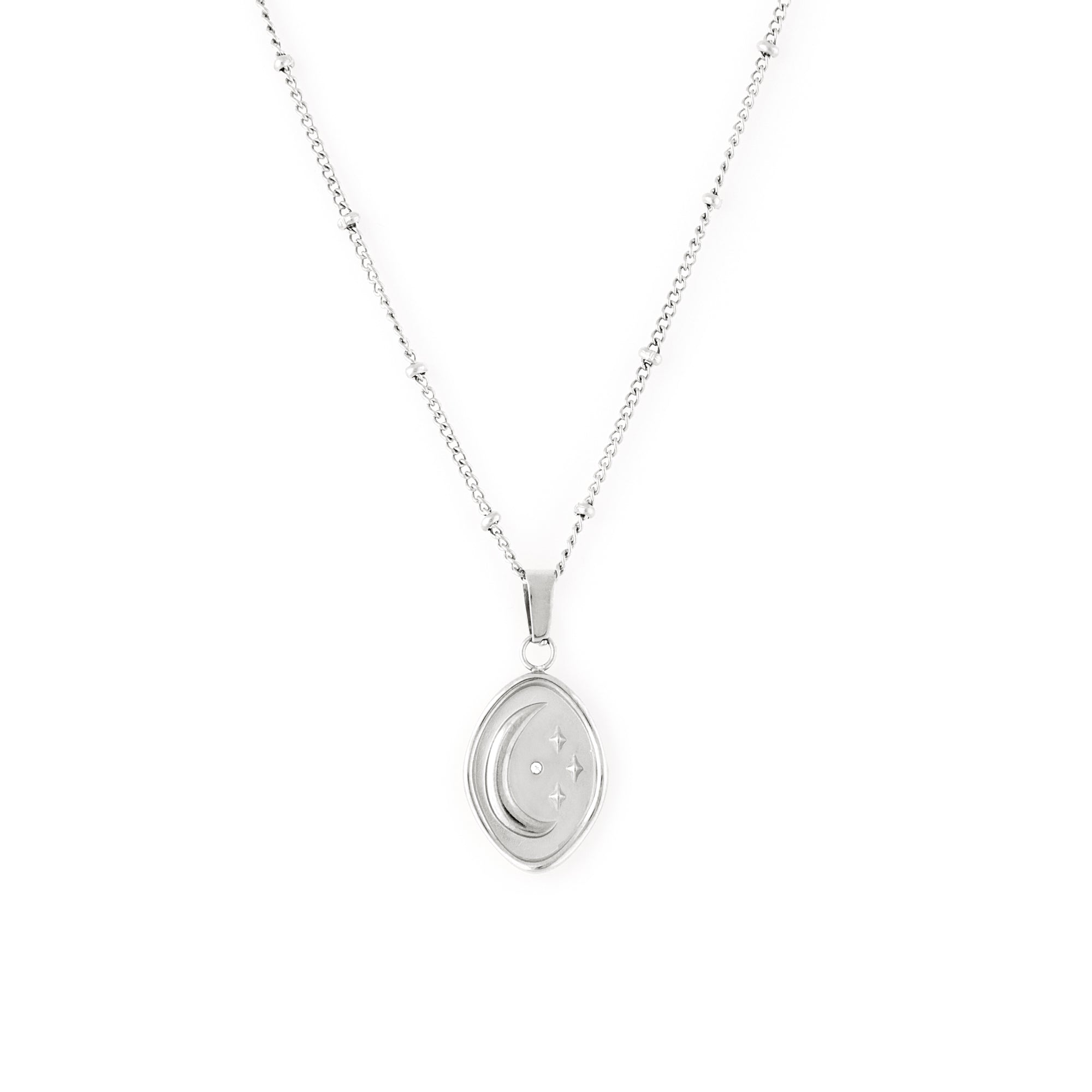  A silver-colored necklace with a beaded chain and an abstract shaped pendant featuring an embossed moon and star with a tiny cubic zirconia stone.