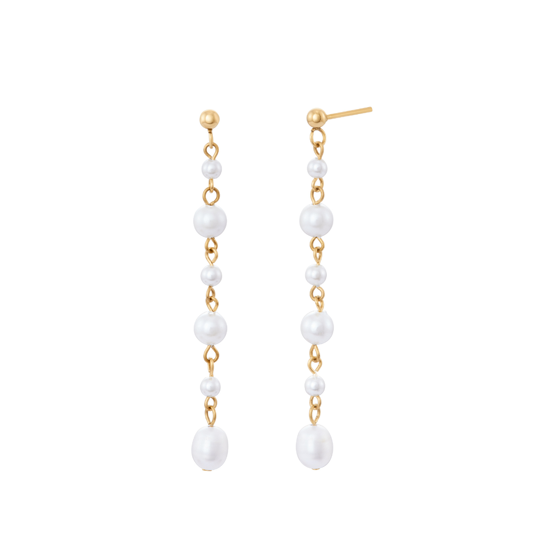 A pair of gold earrings featuring faux pearls strung in a vertical line on a white background.