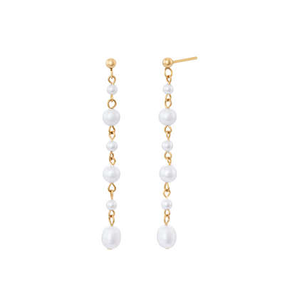 A pair of gold earrings featuring faux pearls strung in a vertical line on a white background.