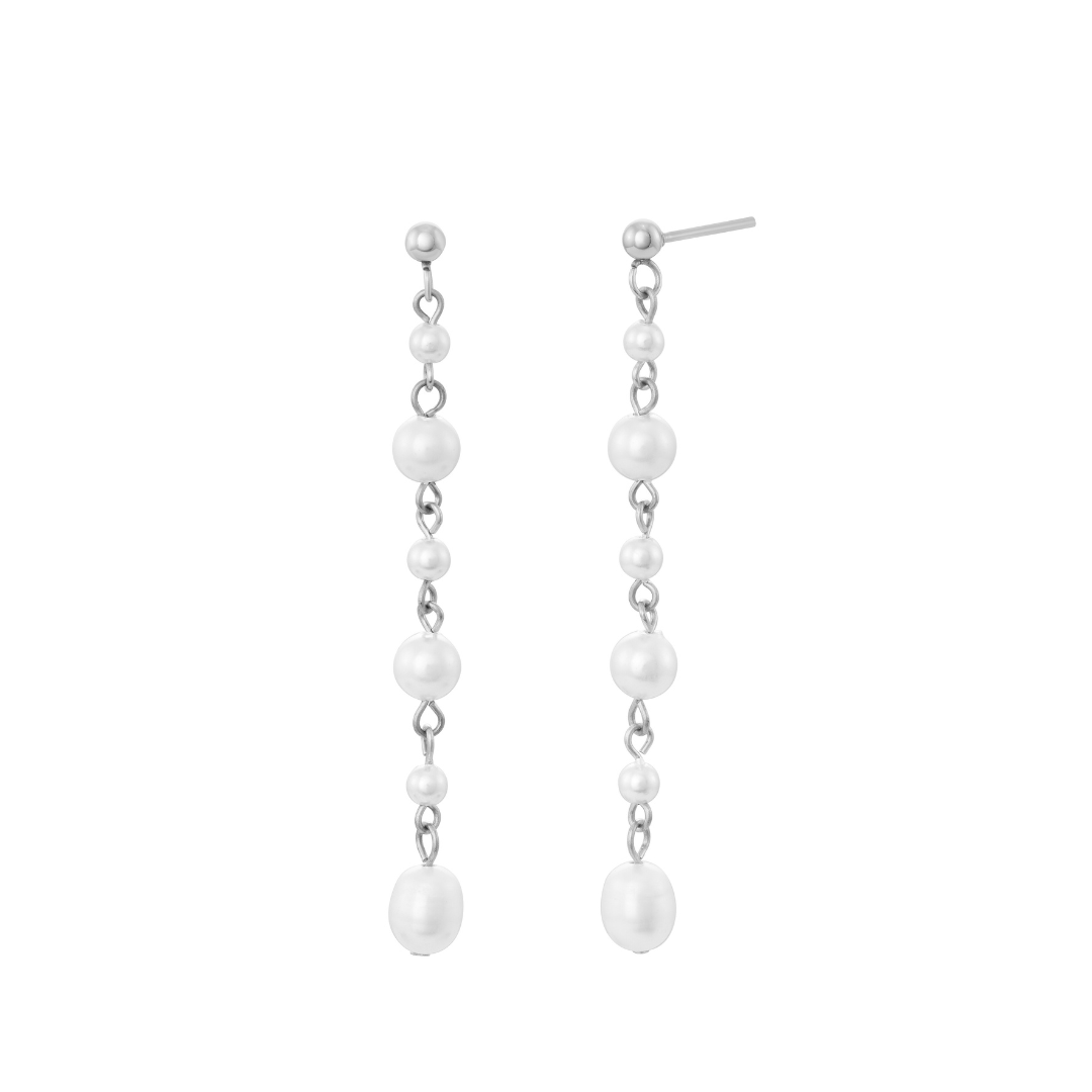 A pair of silver earrings with faux pearls, arranged in a gradient of size from largest at the top to smallest at the bottom, attached to a white background.