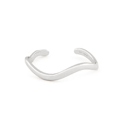  A silver-colored cuff bracelet with an organic shape, displayed against a white background.