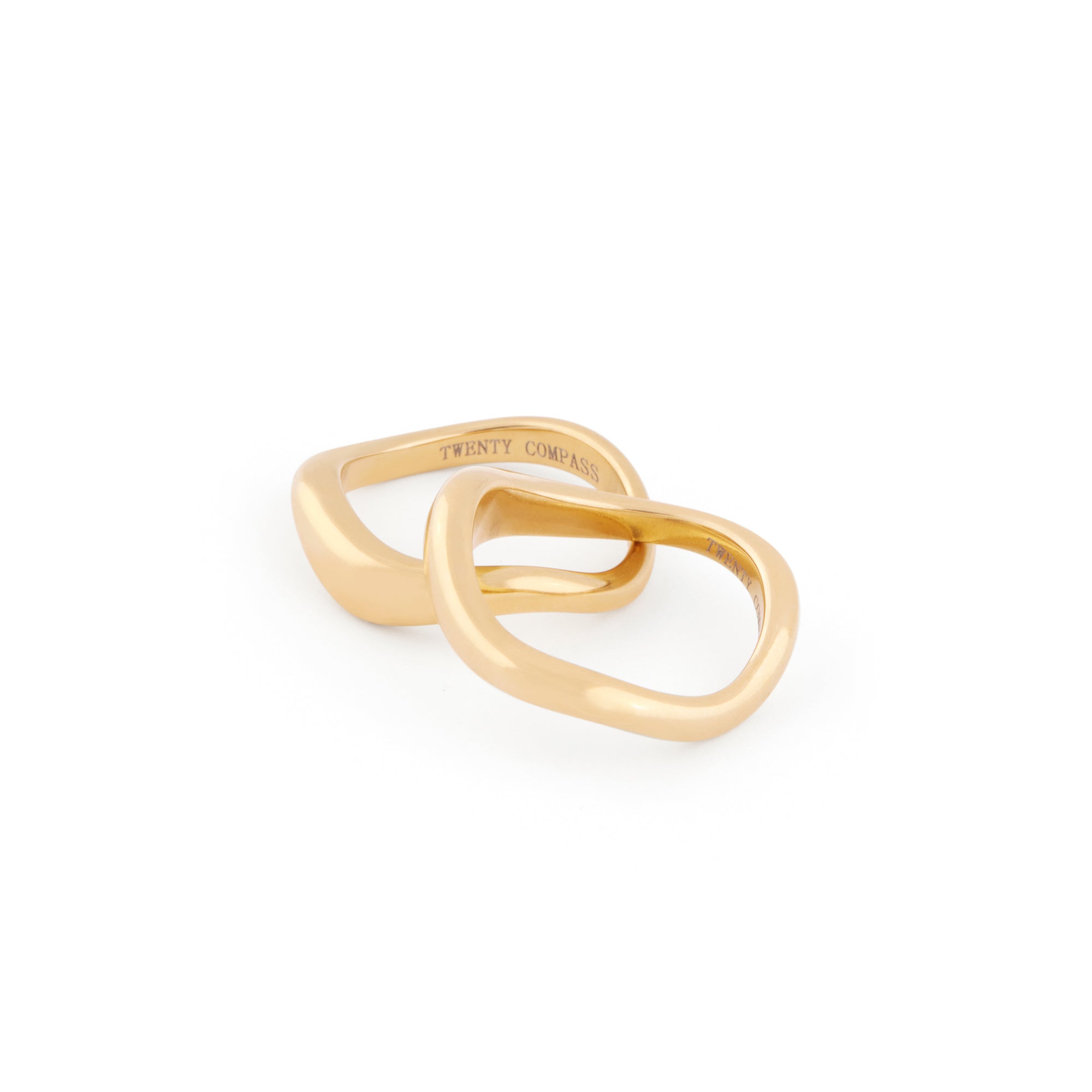 A set of two gold-colored rings with an organic shape, positioned together against a white background.