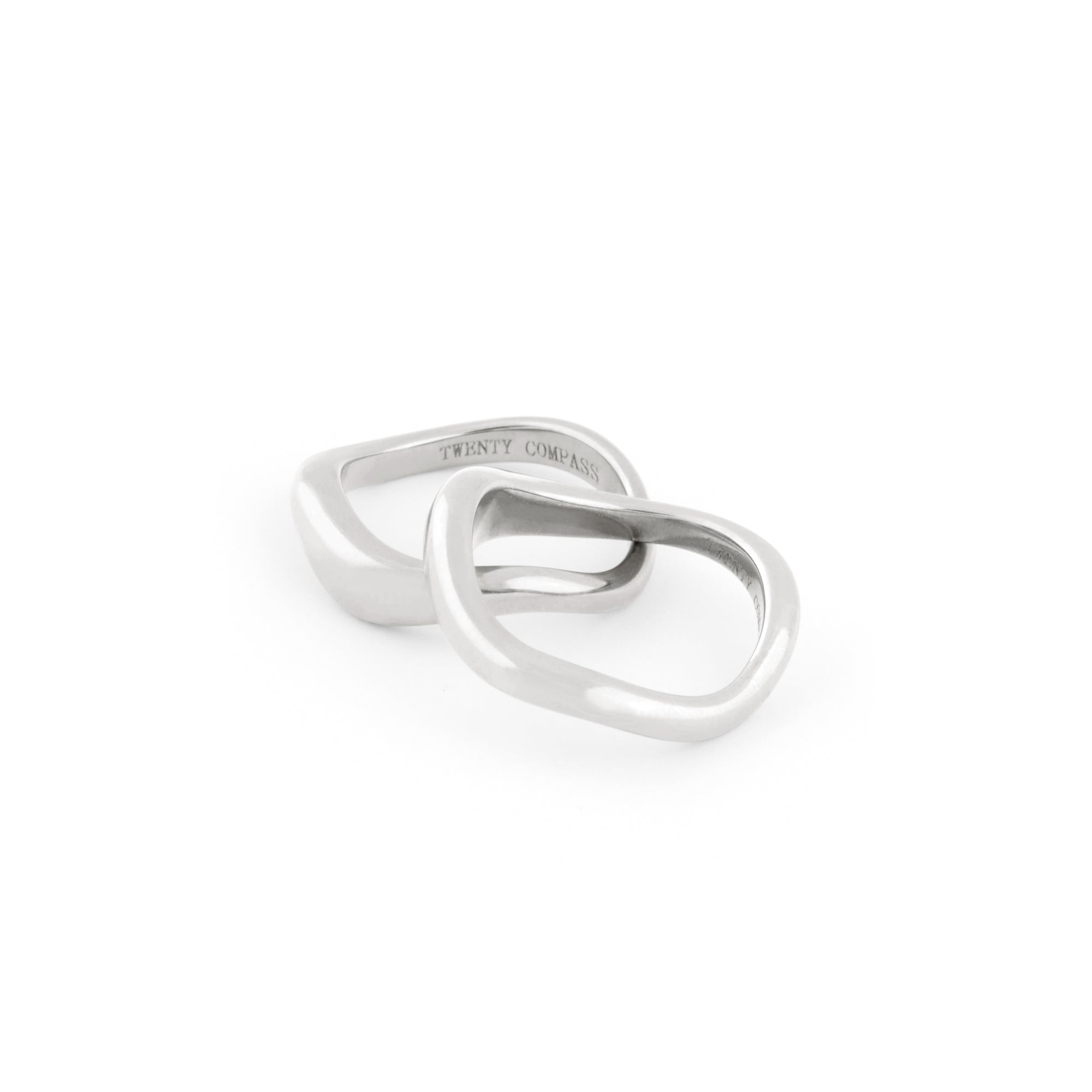A set of two silver rings with organic shapes, positioned against a white background.