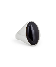 A silver signet ring featuring a large, polished oval black onyx stone, photographed on a seamless white background.