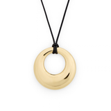 A polished gold-tone circular pendant necklace on a black cord, shown against a plain white background.