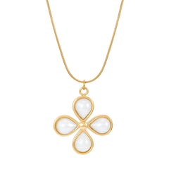 A gold-colored necklace with a flower-shaped pendant adorned with faux pearl detailing on a simple chain.
