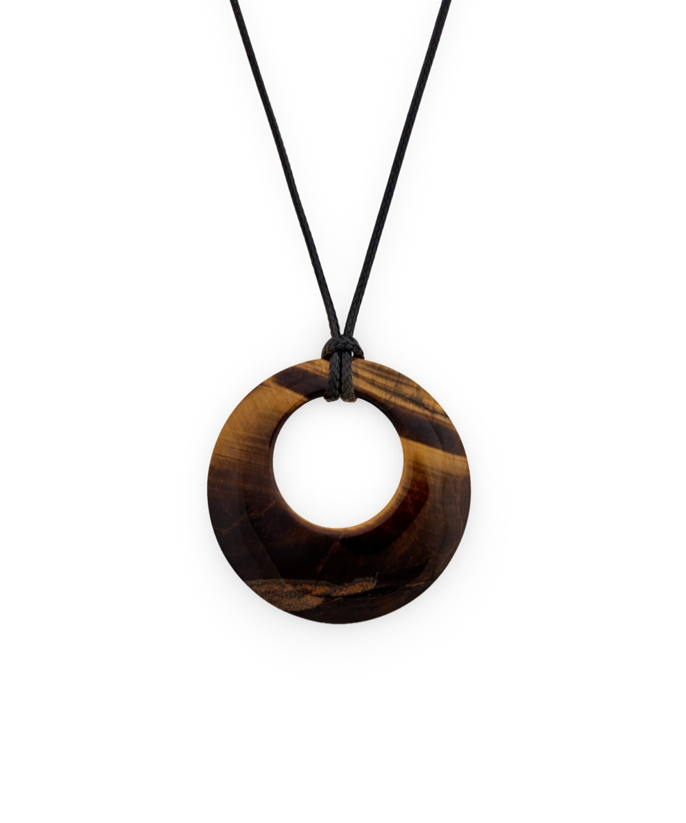 A circular pendant necklace made of polished tiger's eye with natural brown and black banded patterns, suspended from a simple black cord against a solid white background.