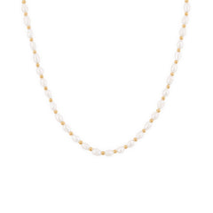 A gold-colored necklace featuring freshwater pearls and small gold beads, designed to rest high on the neckline.