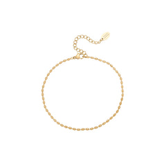 Gold beaded chain anklet on a white background