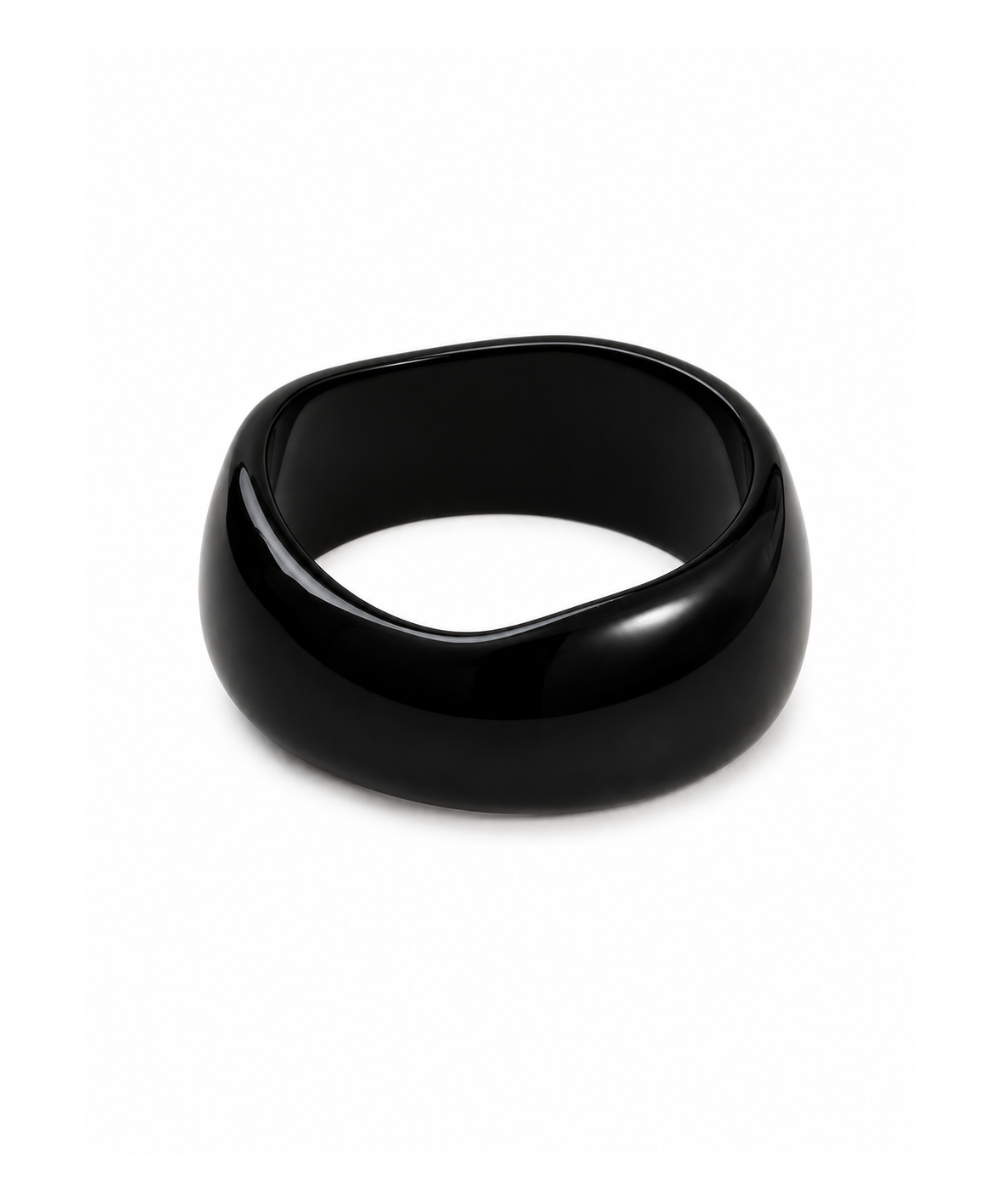 A glossy black resin ring with an organic, wavy silhouette, photographed on a clean white background.