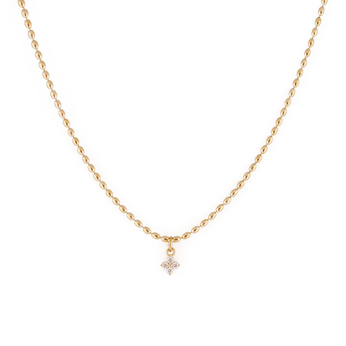 A dainty gold necklace with oval-shaped beads and a cubic zirconia pendant. Collier Merveilles - Or