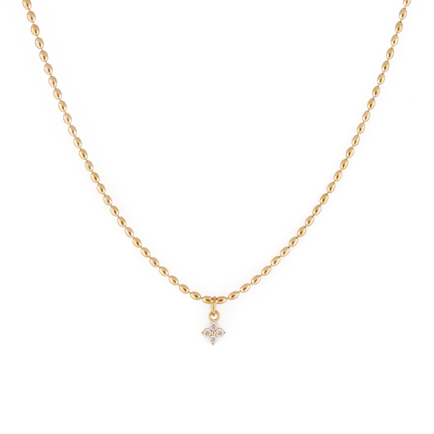 A dainty gold necklace with oval-shaped beads and a cubic zirconia pendant. Collier Merveilles - Or