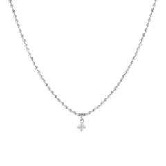 A silver necklace with dainty oval-shaped beads and a cubic zirconia pendant.