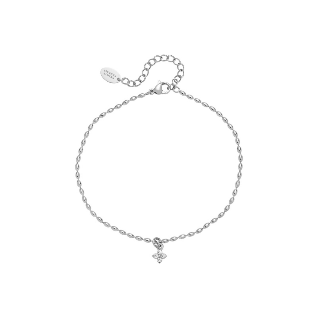 Silver anklet with a small floral charm on a white background