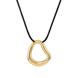 A modern necklace with an irregular, organic-shaped polished gold open-loop pendant suspended from a simple black cord, isolated on a white background.