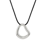 A modern necklace with an irregular, organic-shaped polished silver open-loop pendant suspended from a simple black cord, isolated on a white background.