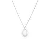 A silver necklace with a dainty organic shaped pendant on a delicate chain.