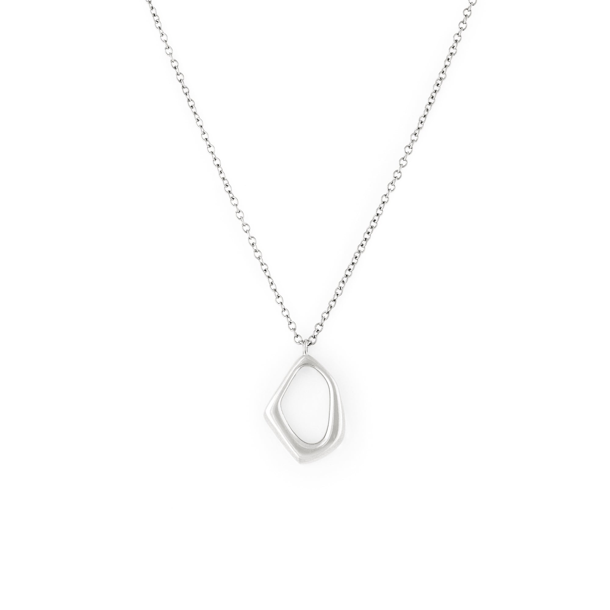 A silver necklace with a dainty organic shaped pendant on a delicate chain.