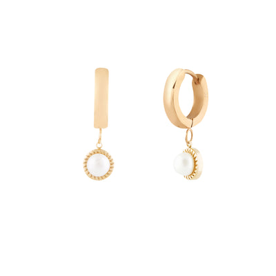 A pair of gold-colored hoop earrings with vintage inspired freshwater pearl pendants on a white background