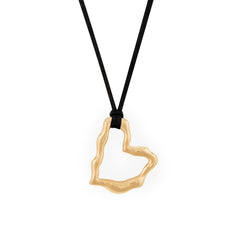 A gold heart-shaped pendant necklace on a black vegan suede cord.
