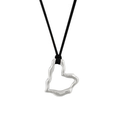 A silver heart-shaped pendant necklace on a black vegan suede cord.