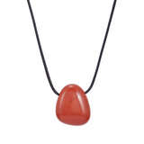 Necklace with a red stone pendant on a white background