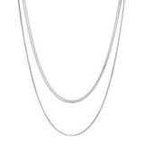 Two silver herringbone chain necklaces, one slightly longer than the other, laid vertically against a white background