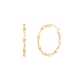A pair of gold-colored metal hoop earrings on a white background