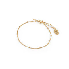 A gold-colored bracelet with a delicate chain and small beads, featuring a clasp mechanism, displayed against a white background.
