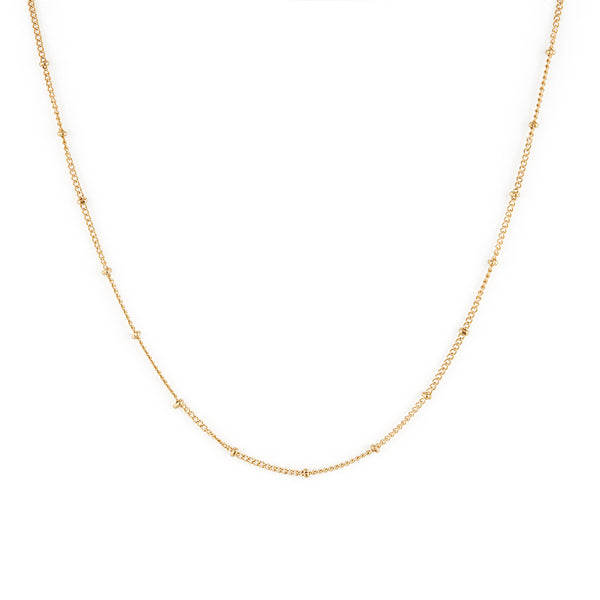 A dainty gold necklace with small spherical embellishments throughout. Sublime Necklace - Gold