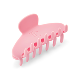Pink shark-shaped hair clip on a white background