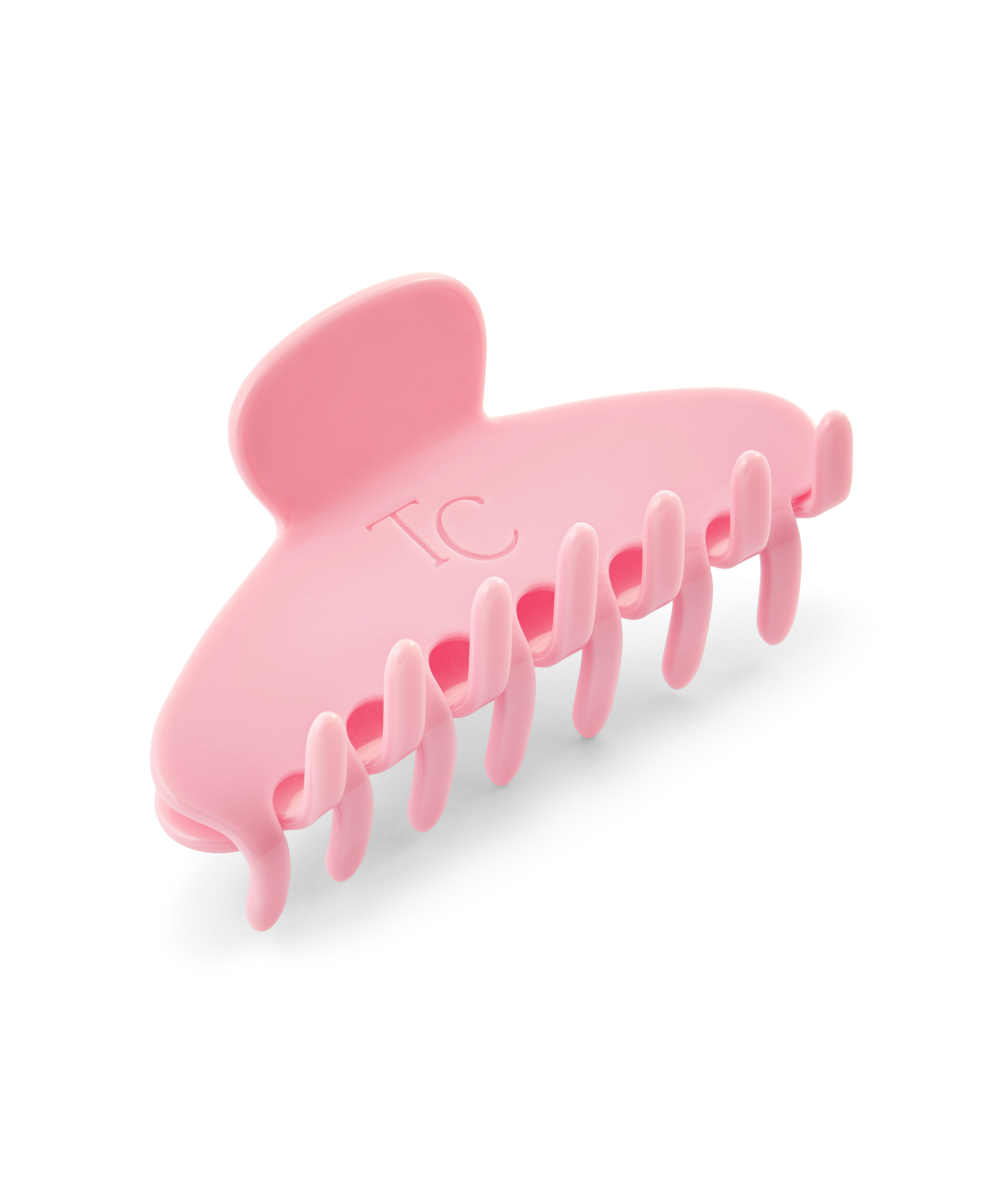Pink shark-shaped hair clip on a white background