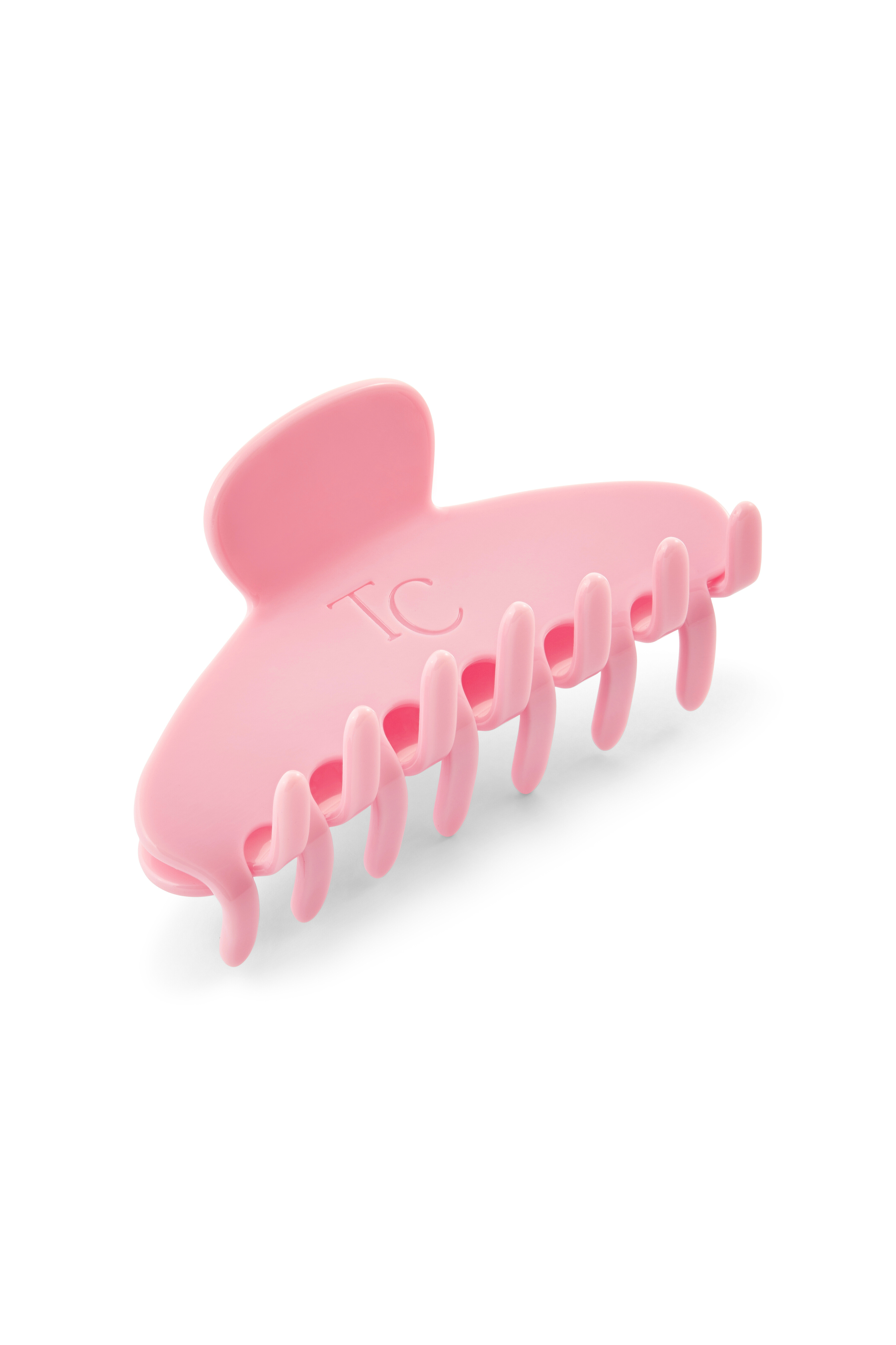 Pink shark-shaped hair clip on a white background