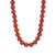 Red beaded necklace on a white background
