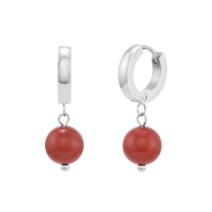 Silver hoop earrings with red beads on a white background