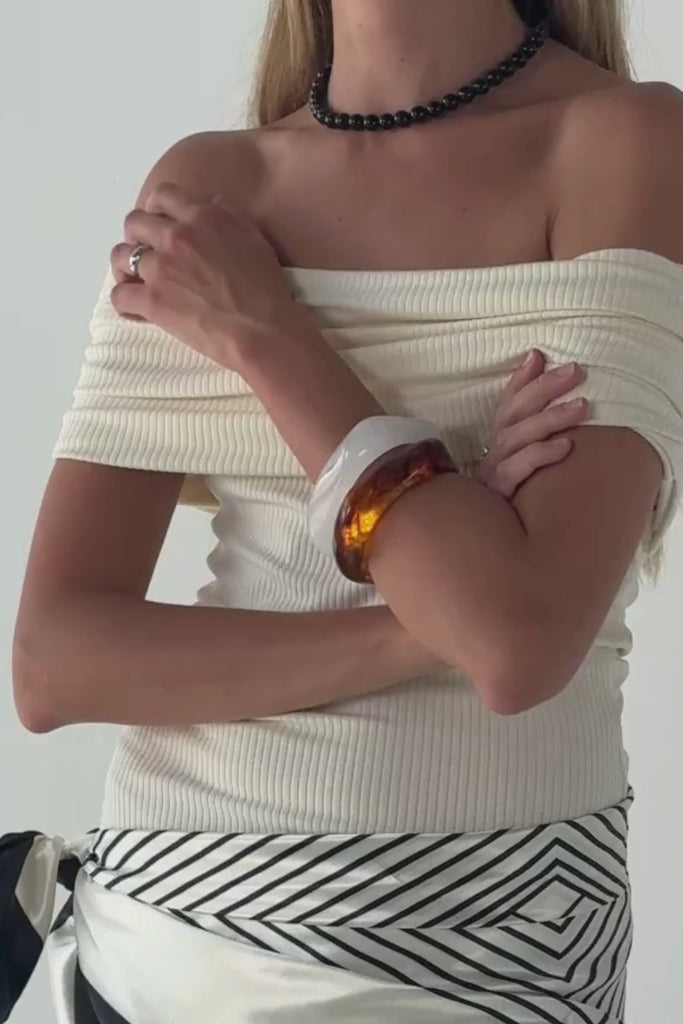Video showing the Frame Bangle  Cloud by Twenty Compass. The video features a close-up of the sculptural resin bracelet, highlighting its unique white and grey marble-patterned texture. The footage captures the matte finish and the bold, square-edged 'frame' design from multiple angles.