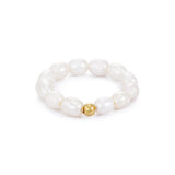 A white pearl ring with a gold-plated stainless steel bead in the center, displayed against a plain background.