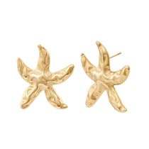 Gold starfish-shaped earrings on a white background