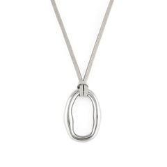 A silver-colored necklace with an organic shaped pendant and a soft vegan suede cord.