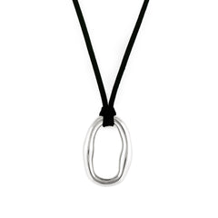 A silver-colored necklace with an organic shaped pendant and a black vegan suede cord.