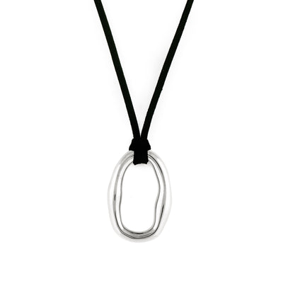A silver-colored necklace with an organic shaped pendant and a black vegan suede cord.