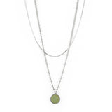 The Andy Necklace - Silver by Twenty Compass is a result of the Sarah-Maude Beauchesne collaboration, showcasing a double-chain design with layered silver chains and a round green aventurine stone pendant on the longer chain, all set against a plain white background.